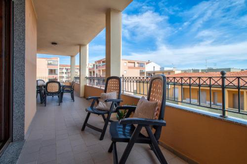 a row of chairs on a balcony with a view at LE TERRAZZE apartments in Alghero