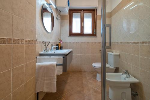 a bathroom with a toilet and a sink at LE TERRAZZE apartments in Alghero
