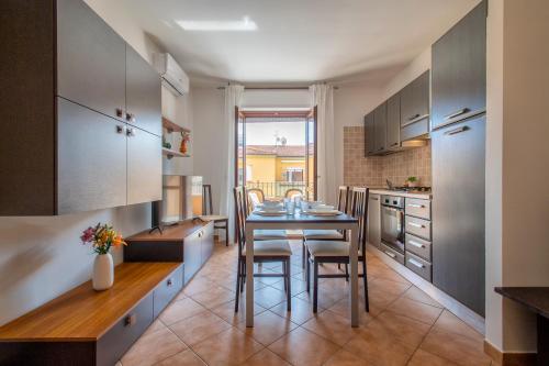 a kitchen with a table and chairs in a room at LE TERRAZZE apartments in Alghero