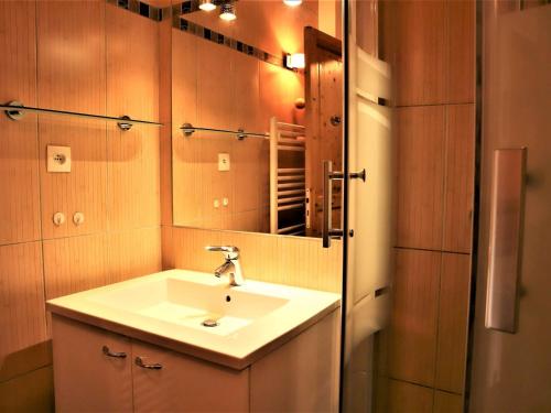 a bathroom with a sink and a mirror at Appartement Auris, 2 pièces, 6 personnes - FR-1-297-26 in Auris