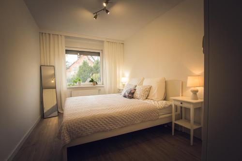 a bedroom with a bed with a window and a mirror at Kwintesencja Natury in Stobnicko