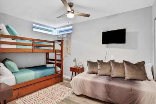 a bedroom with bunk beds and a flat screen tv at Blue Lagoon in Tampa