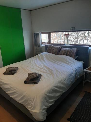 ein Schlafzimmer mit einem Bett mit zwei Handtüchern darauf in der Unterkunft Woning gelegen in rustige bosrijke omgeving in Wingene