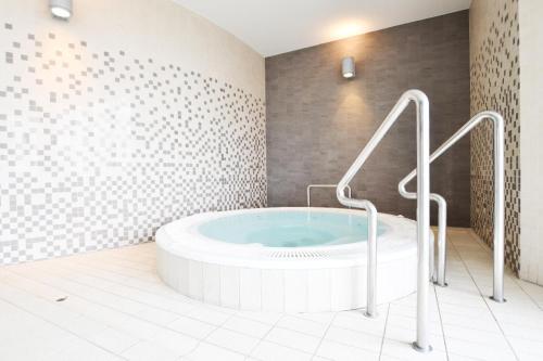 un bagno con una grande vasca in una stanza di Baltic Plaza Resort a Kołobrzeg