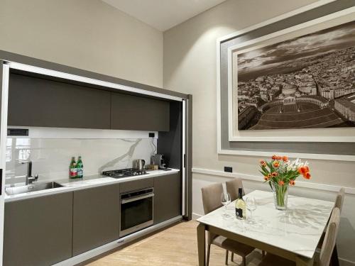 a kitchen with a table and a kitchen with a sink at Napoli Mariana Luxury in Naples