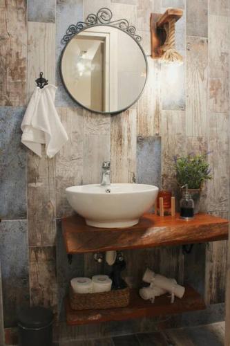 a bathroom with a sink and a mirror at Myrtus Guest House in Myrties