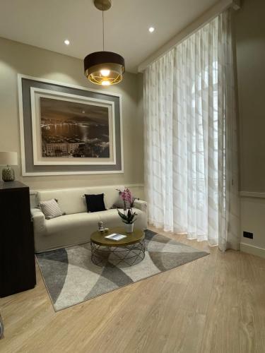 a living room with a couch and a table at Napoli Mariana Luxury in Naples