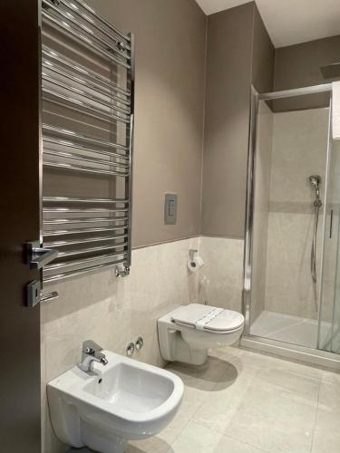 a bathroom with a toilet and a sink and a shower at Napoli Mariana Luxury in Naples