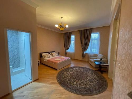 a living room with a bed and a couch at Sisi Guest House in Kutaisi