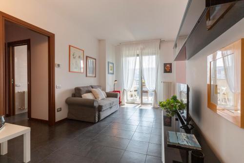 a living room with a couch and a chair at Sky Home Santa Giulia in Milan