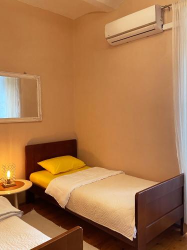 a bedroom with two beds and a air conditioner at S&I room in Kotor