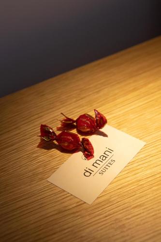 two red peppers on a table next to a paper at Dimani Suites in Gythio