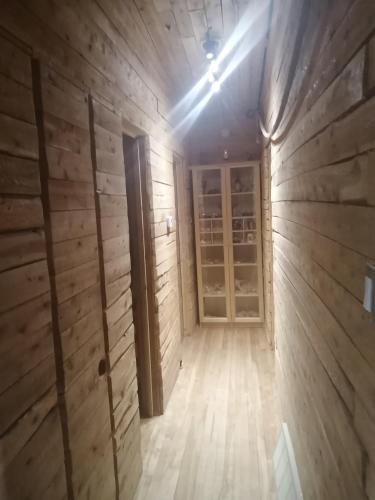 an empty room with wooden walls and a wooden floor at L'Oasis du Pirate in Quebec City