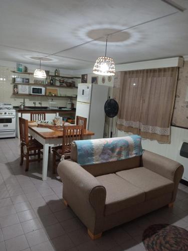 a living room with a couch and a table and a kitchen at La Paz in Lobos