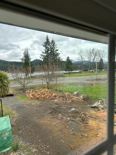 a window view of a yard with a pile of dirt at Foster Lake Inn in Sweet Home