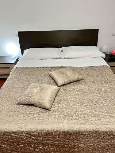 a large bed with two pillows on it at Nuovo appartamento "Lux" in San Benedetto del Tronto