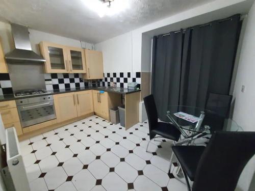 a kitchen with a table and chairs in a room at Spacious Double Bedroom Greater Manchester in Middleton