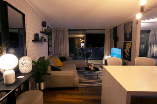a living room with a couch and a table at Luxury apartment 37th floor en distrito de lujo in Santiago