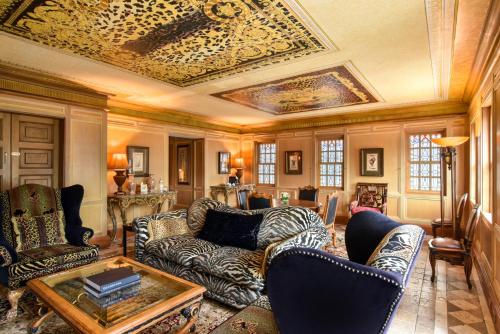 a living room with furniture and a coffered ceiling at The Villa Casa Casuarina in Miami Beach