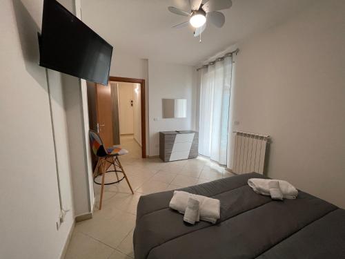 a living room with a couch and a flat screen tv at LA DIMORA DEI SOGNI in Mesagne