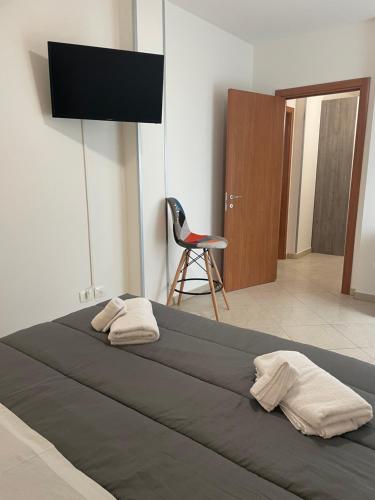 a bedroom with a large bed with a television on the wall at LA DIMORA DEI SOGNI in Mesagne