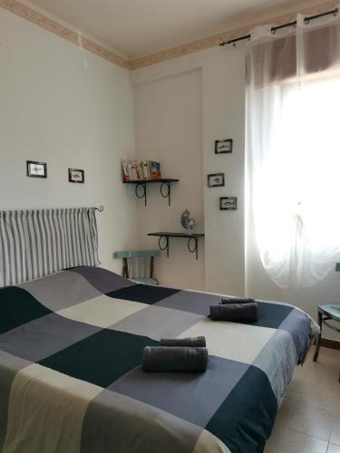 a bedroom with a bed with two pillows on it at Trapani Emotions apartment in Valderice