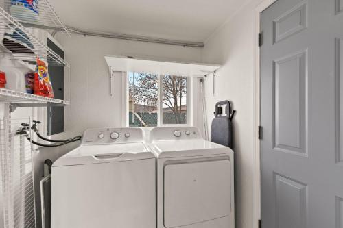a white washing machine in a laundry room with a window at New! Charming 3 bedroom home with HOT-TUB! in Spokane