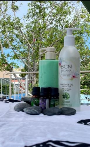 a table with a bottle of lotion and other products on it at Jaco Sol Quadplex 11A in Jacó