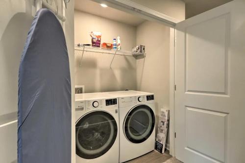 a washing machine in a laundry room with a door at Modern 3BR Townhome 10 mins to Downtown ATL in Atlanta