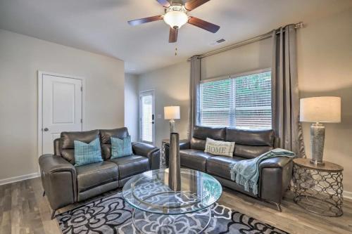 a living room with two leather couches and a table at Modern 3BR Townhome 10 mins to Downtown ATL in Atlanta