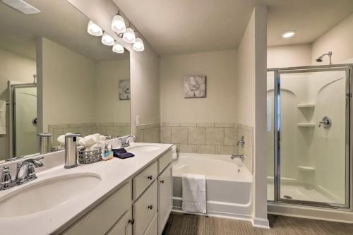 a bathroom with two sinks and a tub and a shower at Modern 3BR Townhome 10 mins to Downtown ATL in Atlanta