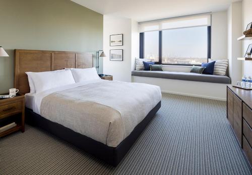 a hotel room with a bed and a couch at The Study at the University of Chicago in Chicago