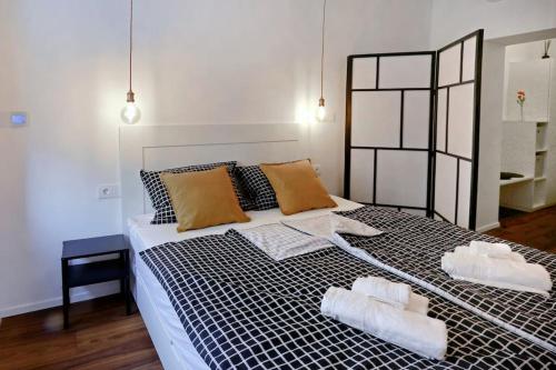 a bedroom with a large bed with two towels on it at Wally apartment in Ljubljana