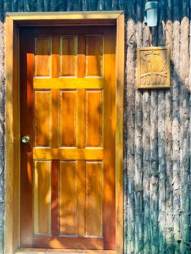 a wooden door on the side of a building at Mariposa Jungle Lodge in San Ignacio