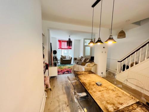 a kitchen and living room with a table and a couch at Stylish Super Central Modern Townhouse Retreat in Brighton & Hove