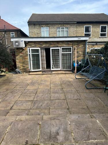 a patio in front of a house at Amazing 4 Bedrooms family home with free parking in Romford