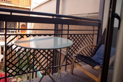 a small table and a chair on a balcony at Bella 269 Guest house in Santiago