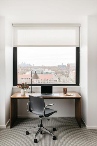 a desk with a window and a laptop on it at The Study at the University of Chicago in Chicago