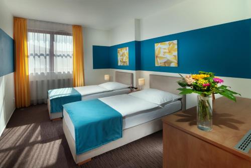 Postel nebo postele na pokoji v ubytování Hotel VZ Bedřichov