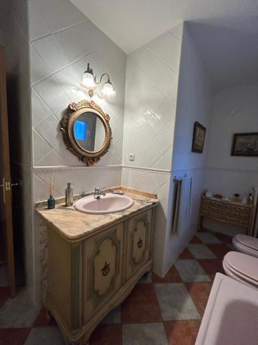 a bathroom with a sink and a mirror at Casa Agapito Marazuela in Segovia