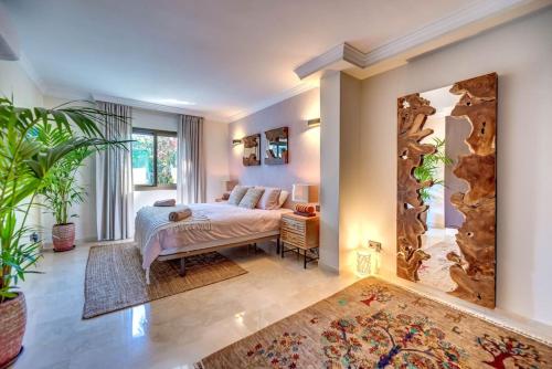 een slaapkamer met een bed en een grote spiegel bij Beachfront apartment in Marbella