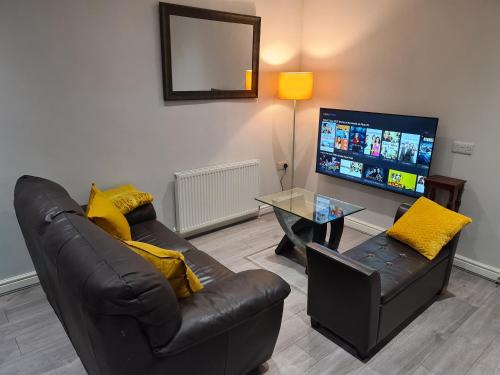 a living room with two couches and a tv at Whole House - 4 Bedrooms - Parking - Sleeps 8 in Birmingham