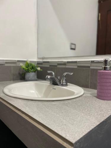 a white sink in a bathroom with a mirror at Hotel Boutique Los Pinos in Santa Rosa de Copán
