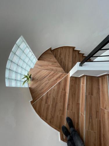 a person is standing on the floor of a spiral staircase at Hotel Boutique Los Pinos in Santa Rosa de Copán