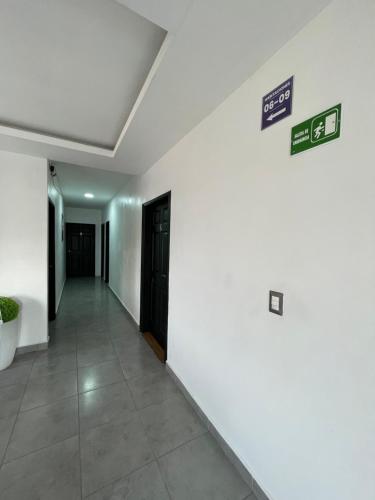 a hallway in a building with signs on the wall at Hotel Boutique Los Pinos in Santa Rosa de Copán