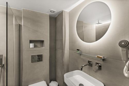 W łazience znajduje się umywalka i lustro. w obiekcie Marina w mieście Kardamyli