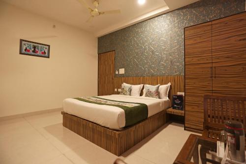 a bedroom with a bed with a wooden wall at Super Capital O Hotel Swastika in Jaipur