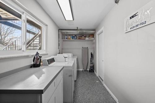 een keuken met witte werkbladen en een raam bij Bright & Spacious 2 Bedroom, Quiet in Mount Clemens