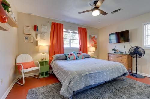 a bedroom with a bed and a tv in it at Vibrant Pass Christian Oasis - 3 Blocks to Beach! in Pass Christian