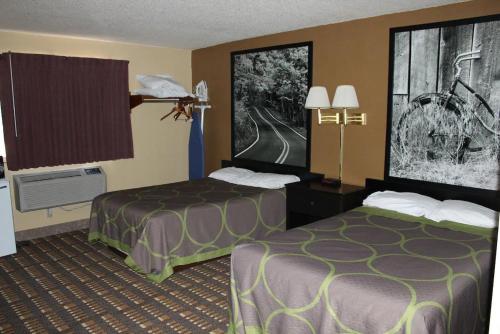 a hotel room with two beds in a room at Coratel Inn & Suites by Jasper Stillwater in Stillwater